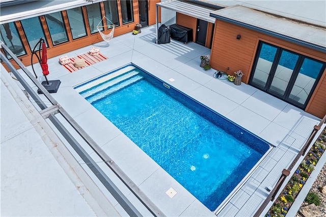 view of swimming pool with a patio