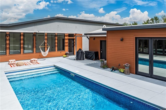 view of swimming pool with a patio area