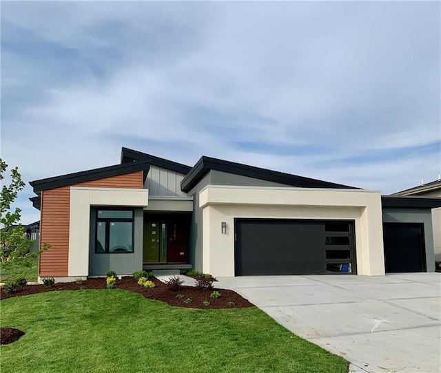 contemporary house with a garage and a front yard