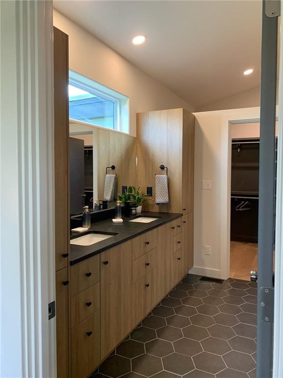 bathroom featuring tile floors and lofted ceiling