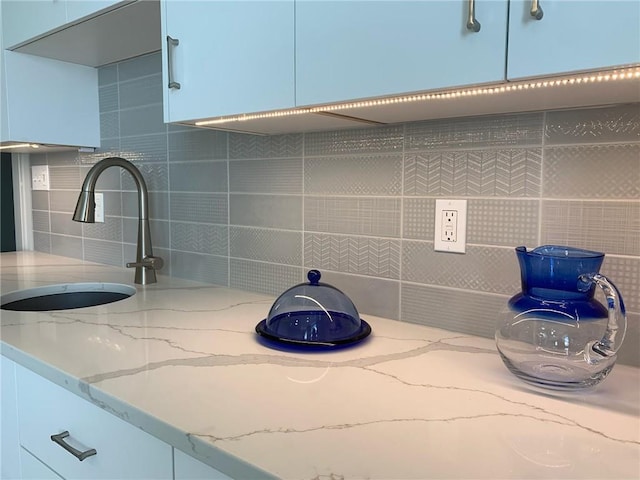 interior space with sink and backsplash