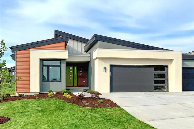 contemporary house featuring a front lawn and a garage