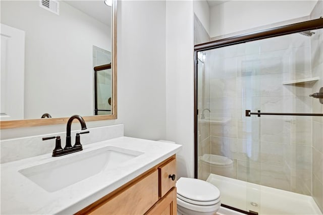 full bath with visible vents, toilet, and a shower stall