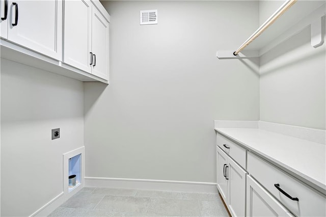 laundry area with visible vents, baseboards, cabinet space, and electric dryer hookup