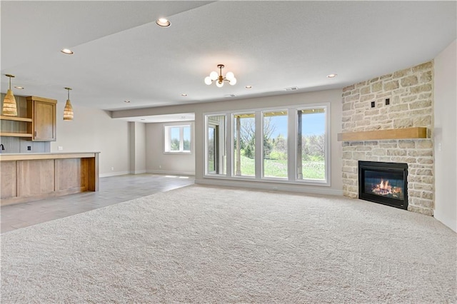 unfurnished living room featuring baseboards, recessed lighting, and light carpet