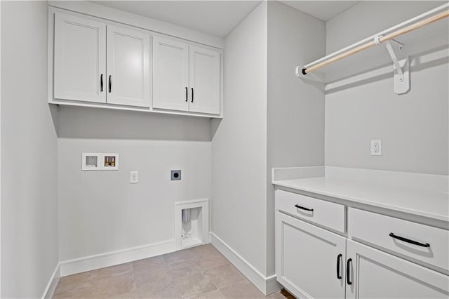 laundry room with baseboards, hookup for a washing machine, electric dryer hookup, and cabinet space
