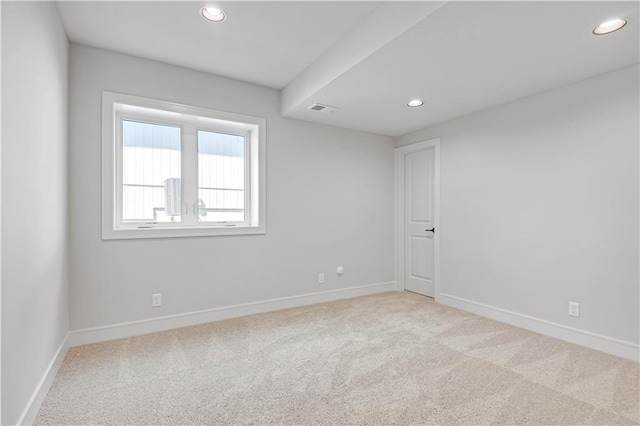 spare room featuring recessed lighting and carpet