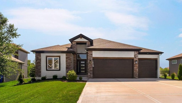 prairie-style home featuring a garage and a front lawn