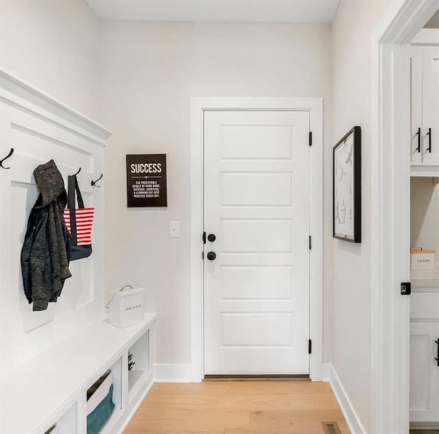 mudroom with light hardwood / wood-style floors