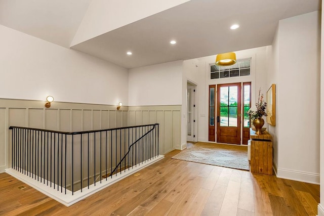 foyer entrance featuring vaulted ceiling and hardwood / wood-style floors