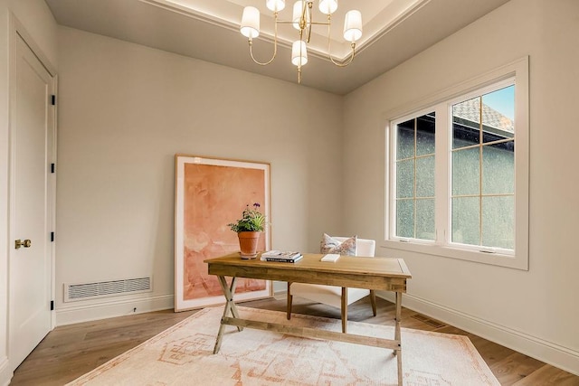 office featuring wood-type flooring and a chandelier