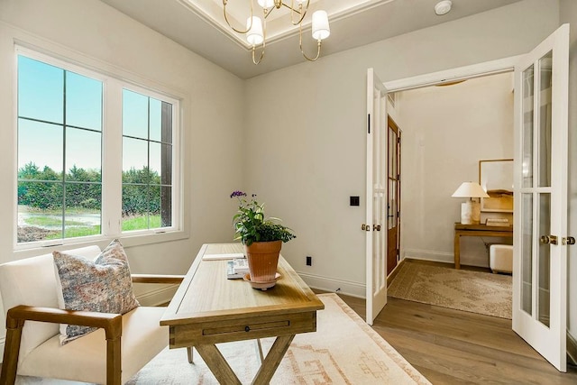 living area with a notable chandelier and hardwood / wood-style flooring