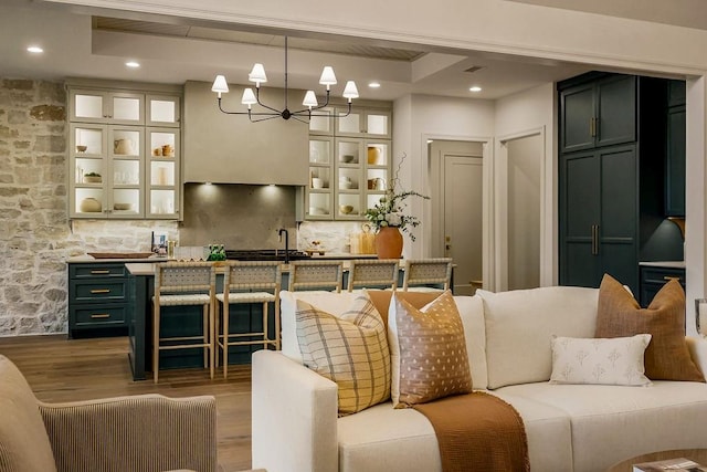 living room with a chandelier and wood-type flooring