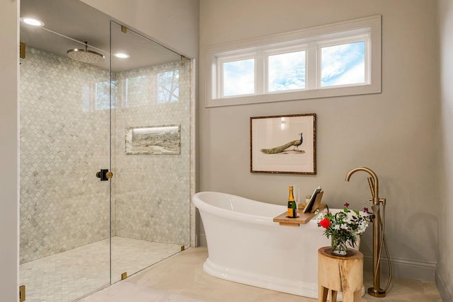 bathroom featuring a healthy amount of sunlight and plus walk in shower