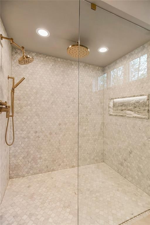 bathroom with tiled shower