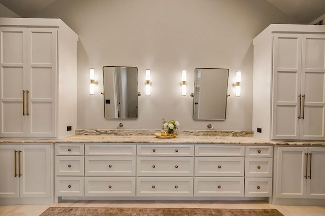 bathroom featuring vanity and vaulted ceiling