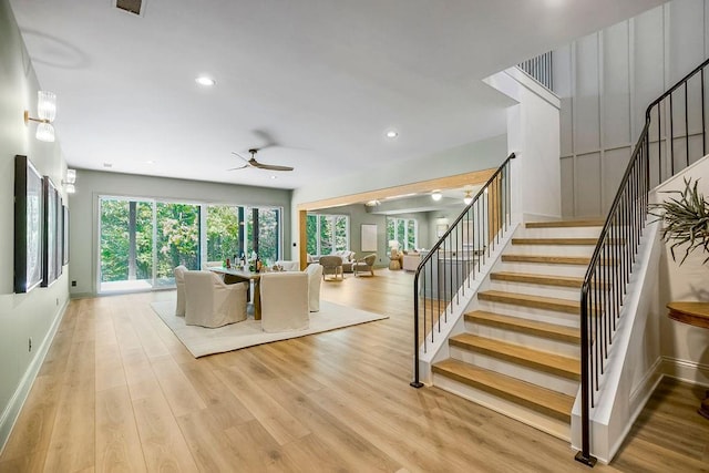 unfurnished living room with light hardwood / wood-style flooring and ceiling fan