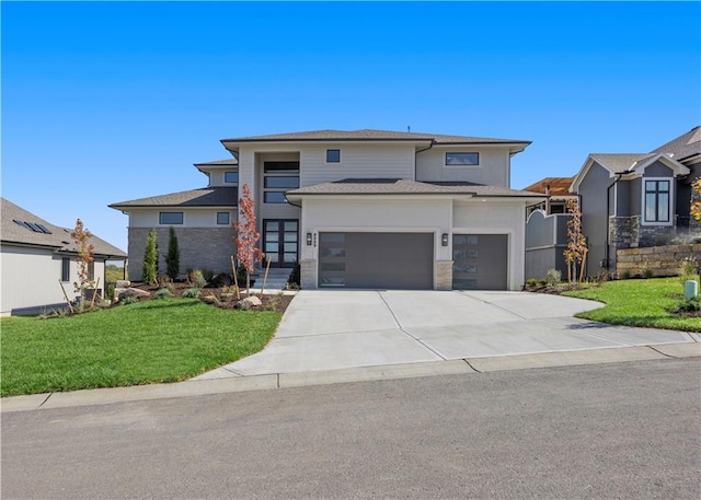 prairie-style home with a front yard and a garage