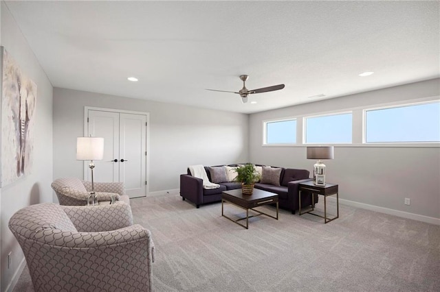 living room with light carpet and ceiling fan