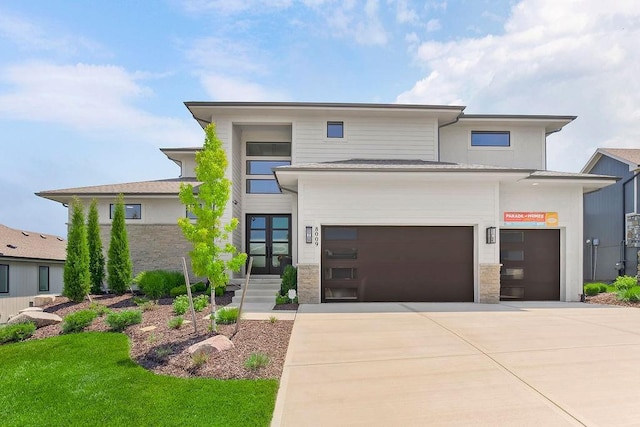 8009 Millridge St, Shawnee, KS 66220 - view of front facade with stone siding, an attached garage, and driveway
