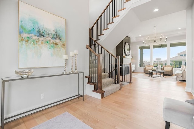 8009 Millridge St, Shawnee, KS 66220 - foyer entrance with stairs, wood finished floors, a chandelier, recessed lighting, and a baseboard heating unit