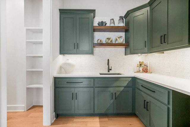 8009 Millridge St, Shawnee, KS 66220 - kitchen with green cabinetry, open shelves, light countertops, backsplash, and light wood-style flooring