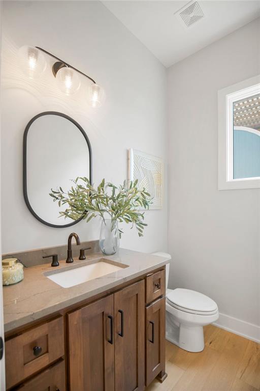 8009 Millridge St, Shawnee, KS 66220 - bathroom featuring vanity and wood finished floors