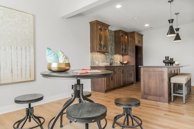8009 Millridge St, Shawnee, KS 66220 - indoor bar featuring light wood-style flooring, recessed lighting, and decorative light fixtures