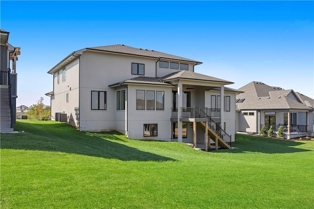 8009 Millridge St, Shawnee, KS 66220 - rear view of house with stairway, a lawn, a ceiling fan, and a shingled roof