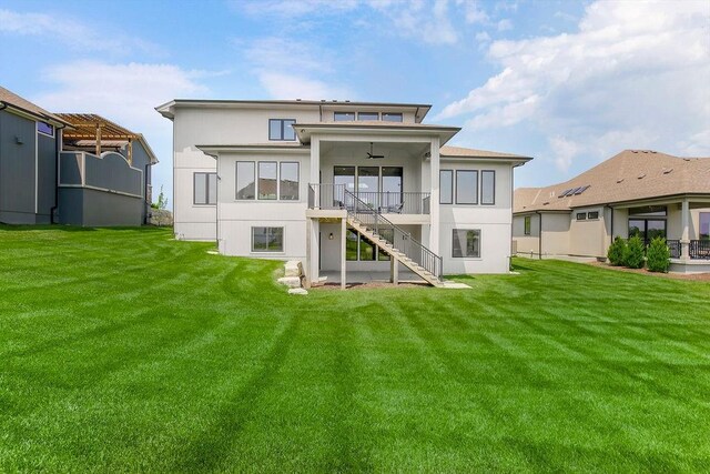 8009 Millridge St, Shawnee, KS 66220 - back of house with stairway, a lawn, ceiling fan, and stucco siding