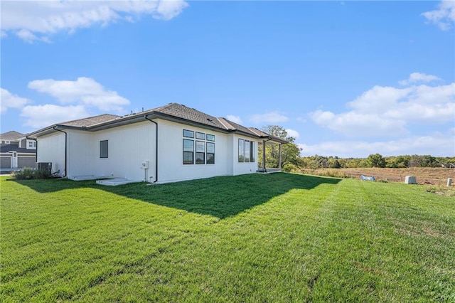 view of side of home with a lawn