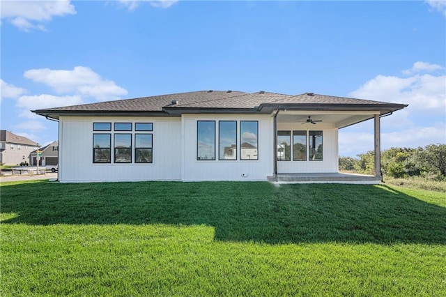 back of house featuring ceiling fan and a lawn