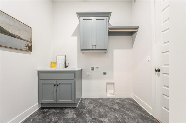 washroom featuring hookup for an electric dryer, cabinets, sink, and washer hookup