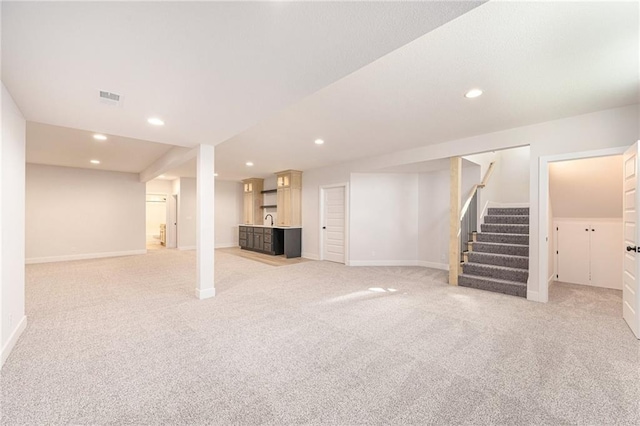 basement featuring light colored carpet