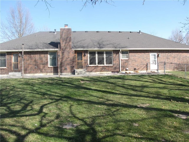 rear view of property with a lawn