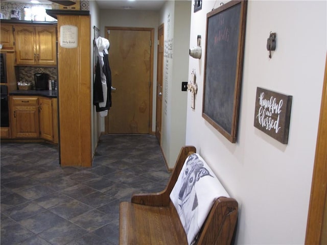 hallway featuring dark tile floors