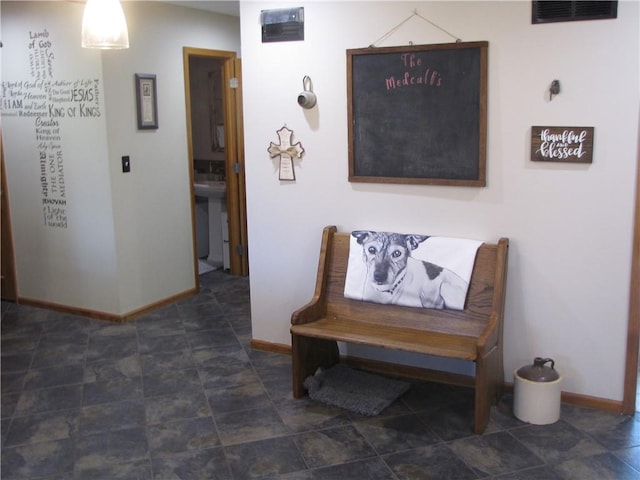 corridor featuring sink and dark tile floors