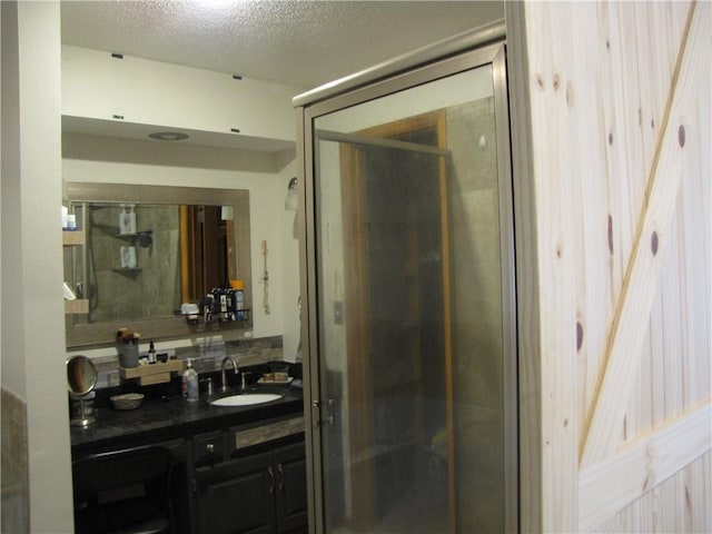 bathroom featuring a textured ceiling and oversized vanity