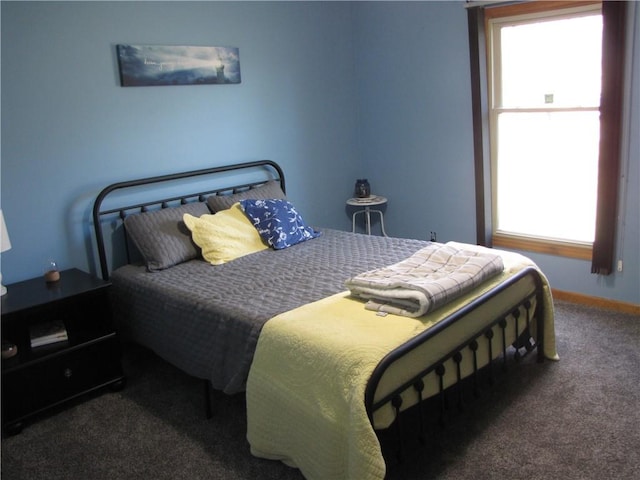 carpeted bedroom featuring multiple windows