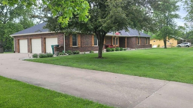 ranch-style house featuring a front yard and a garage