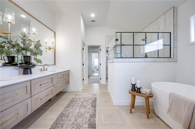 bathroom with double vanity, tile floors, plus walk in shower, and lofted ceiling