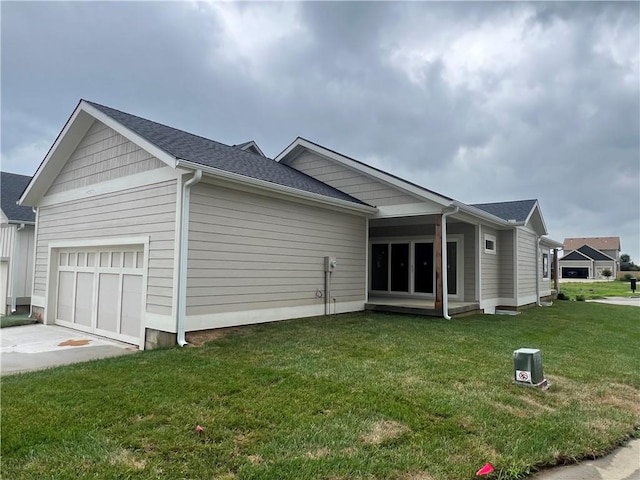 view of property exterior with a yard and a garage