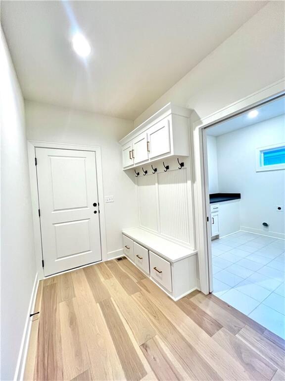 mudroom with light hardwood / wood-style flooring