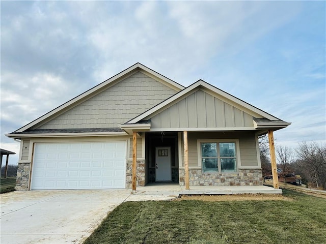 craftsman-style house with a front lawn, covered porch, and a garage