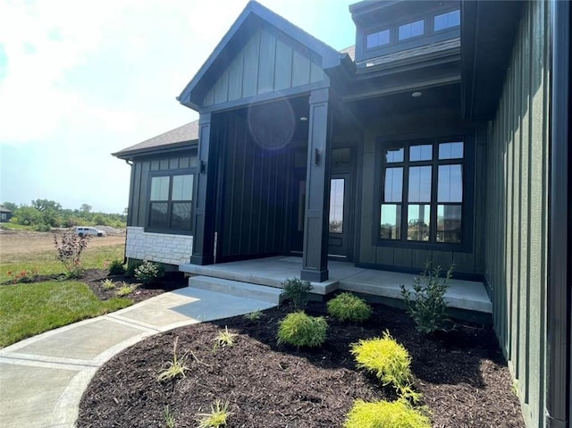 entrance to property featuring covered porch and board and batten siding