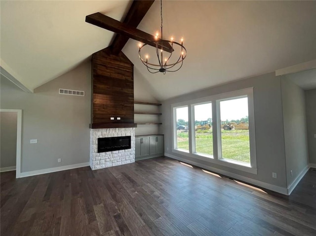 unfurnished living room with visible vents, beamed ceiling, dark wood-style flooring, a stone fireplace, and a chandelier