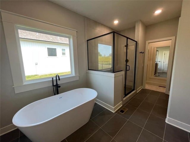 full bath featuring recessed lighting, a soaking tub, visible vents, and a shower stall