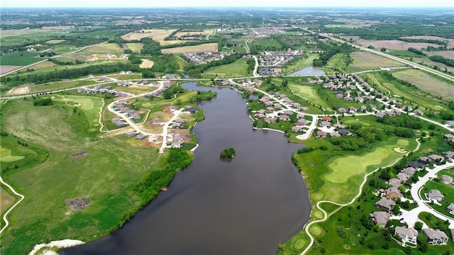 birds eye view of property featuring view of golf course and a water view