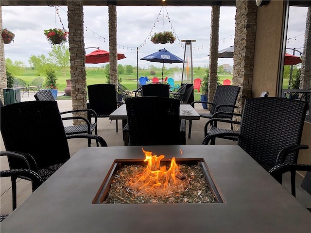 view of patio featuring a fire pit and outdoor dining space