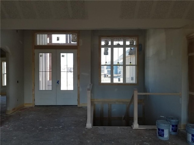 entryway with arched walkways and french doors